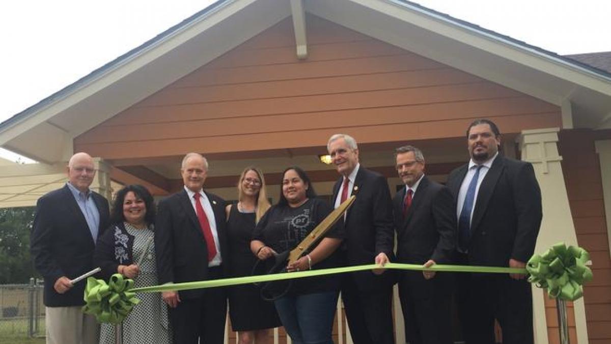 Claudia Mejia, Rep. Lloyd Doggett, and others at the unveiling of a "green" home